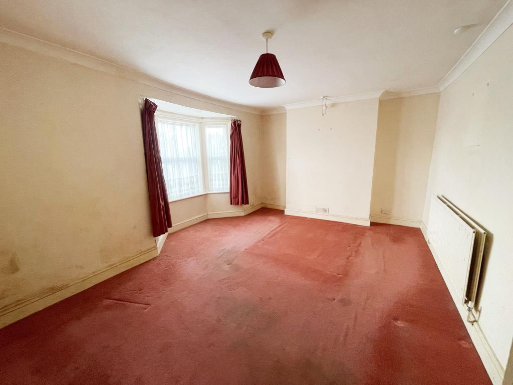 Lot: 77 - MID-TERRACE HOUSE FOR IMPROVEMENT IN TOWN CENTRE - Bedroom One with bay window